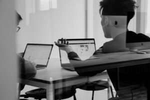 Two professionals reviewing a conflicts of interest register